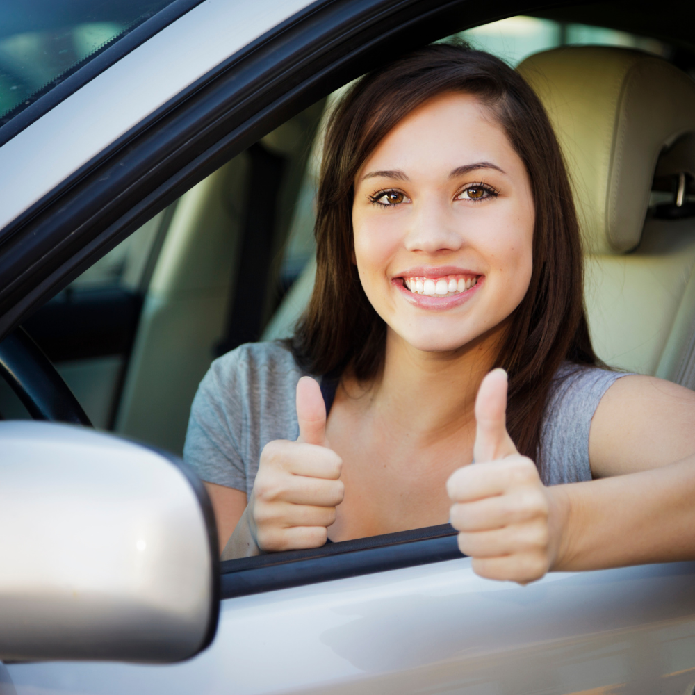 woman in cars thumbs up